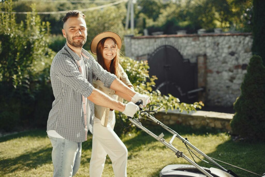 Man and Woman Holding Gray Grass Cutter